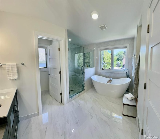 bathroom featuring vanity, visible vents, marble finish floor, a soaking tub, and a marble finish shower