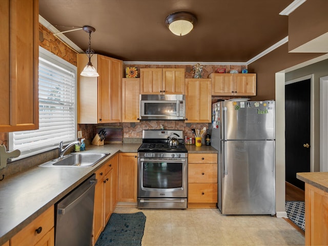 kitchen featuring appliances with stainless steel finishes, a sink, crown molding, pendant lighting, and backsplash