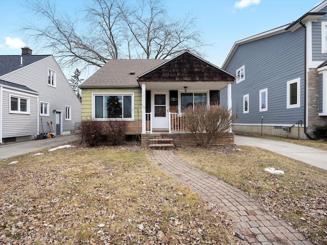 view of front of home featuring a porch and a shingled roof