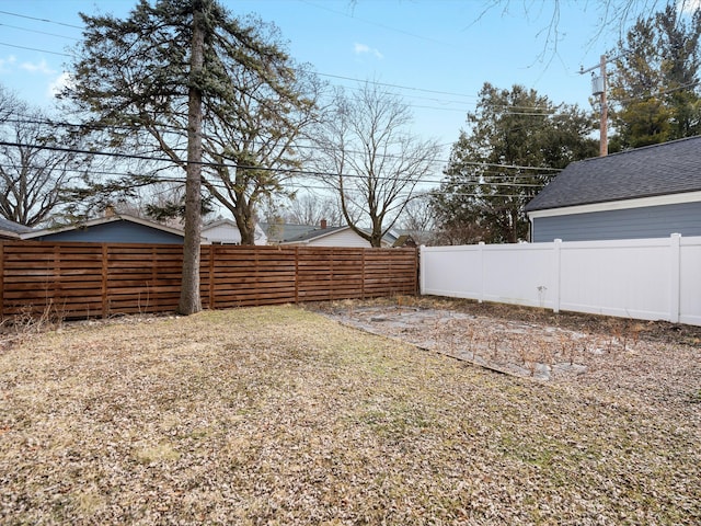 view of yard with a fenced backyard