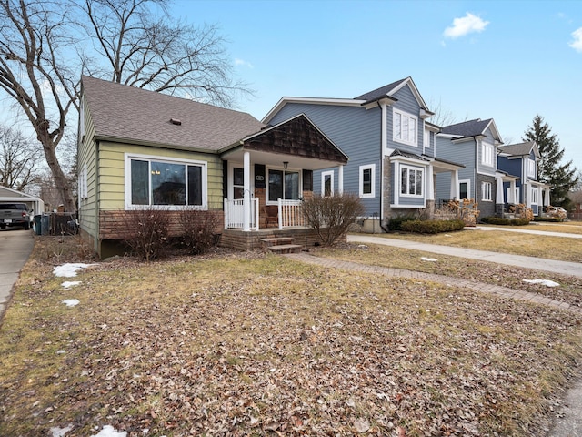 view of front facade with a porch and a shingled roof