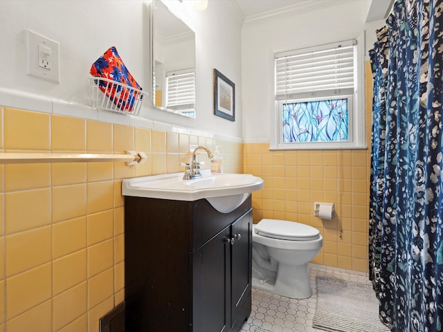 full bathroom featuring toilet, a wainscoted wall, ornamental molding, tile patterned flooring, and vanity