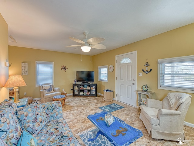 living room featuring ceiling fan and baseboards