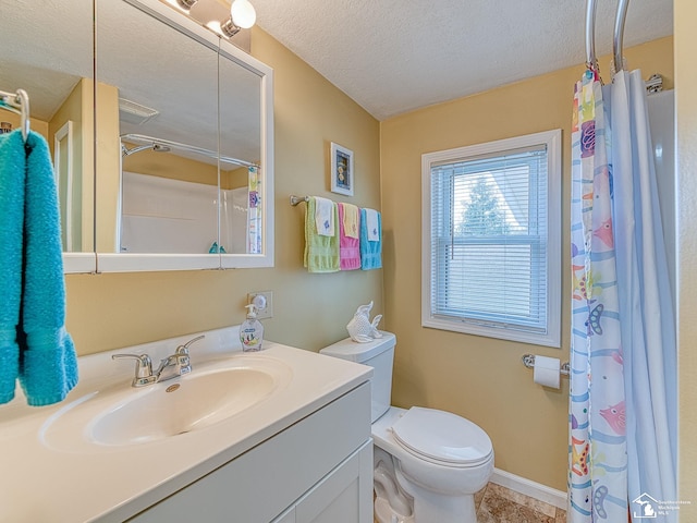 bathroom featuring a textured ceiling, curtained shower, vanity, and toilet