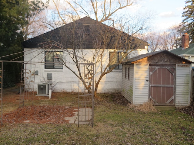 view of side of home featuring an outbuilding, central AC unit, and a shed