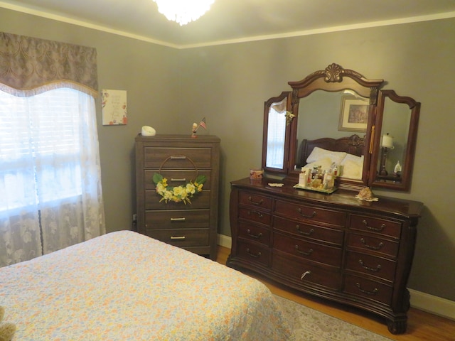 bedroom featuring baseboards and wood finished floors