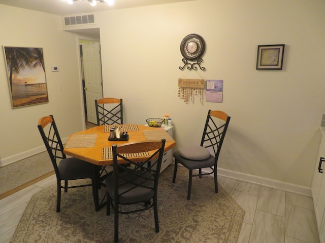 dining room with visible vents and baseboards