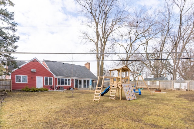 view of playground with a fenced backyard and a yard