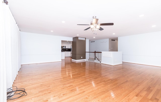 unfurnished living room with light wood finished floors, recessed lighting, visible vents, and baseboards