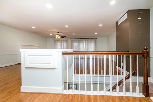 hall featuring recessed lighting, visible vents, baseboards, and wood finished floors