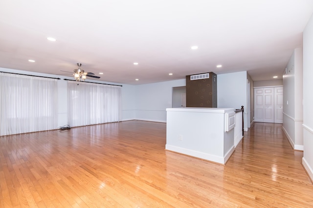 spare room featuring ceiling fan, baseboards, light wood-style flooring, and recessed lighting