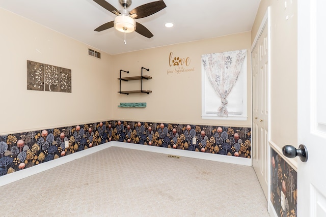 carpeted empty room featuring ceiling fan, visible vents, and recessed lighting