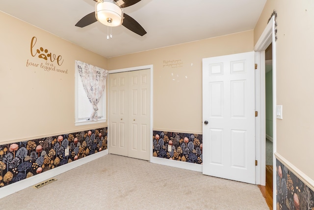 bedroom featuring baseboards, ceiling fan, visible vents, and a closet