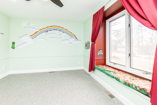 recreation room featuring baseboards, carpet floors, visible vents, and a healthy amount of sunlight