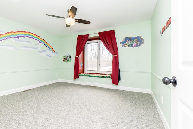 interior space featuring carpet floors, visible vents, ceiling fan, and baseboards