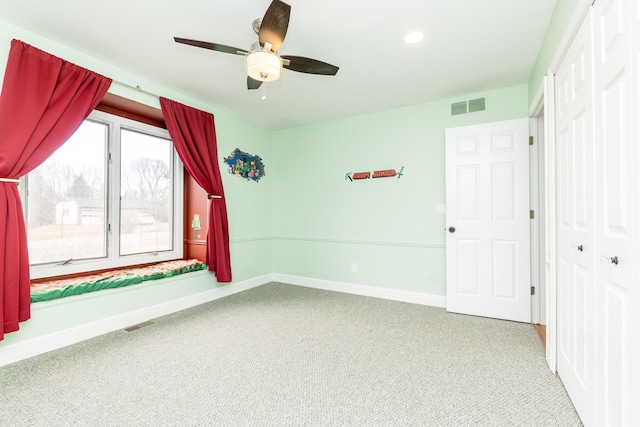 interior space featuring carpet, visible vents, and baseboards