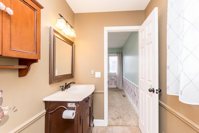 bathroom featuring tile patterned flooring, vanity, and baseboards