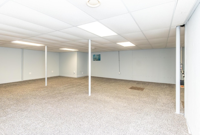 finished basement with carpet floors and a drop ceiling