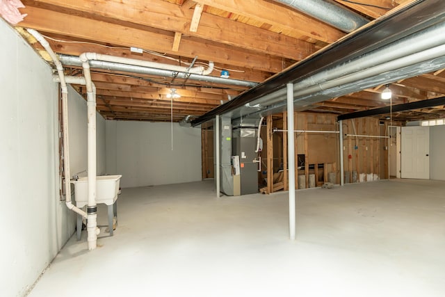 unfinished basement featuring heating unit