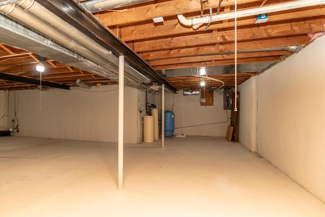 unfinished basement featuring electric panel