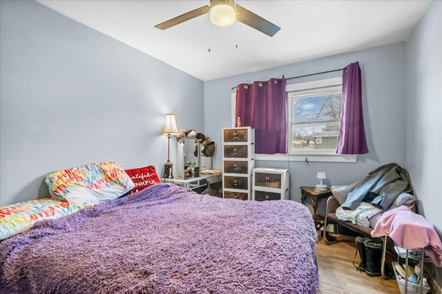 bedroom featuring a ceiling fan and wood finished floors