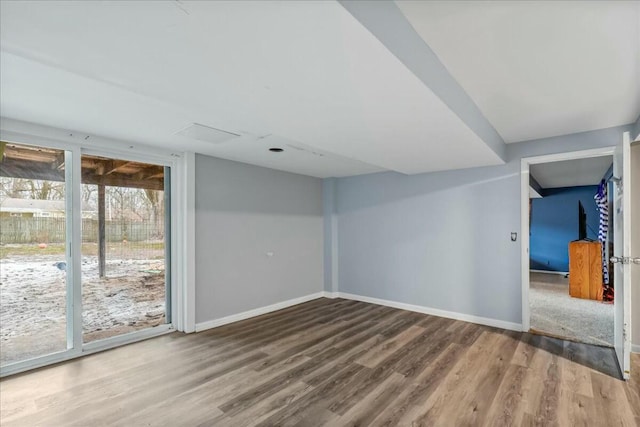 empty room with baseboards and wood finished floors