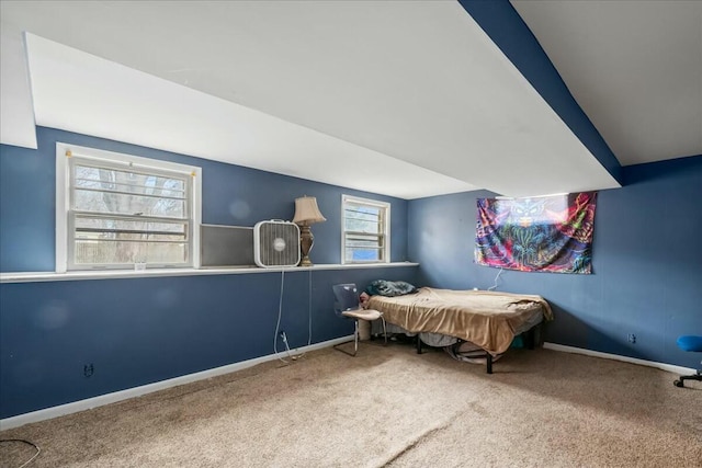 bedroom with carpet floors, baseboards, and vaulted ceiling