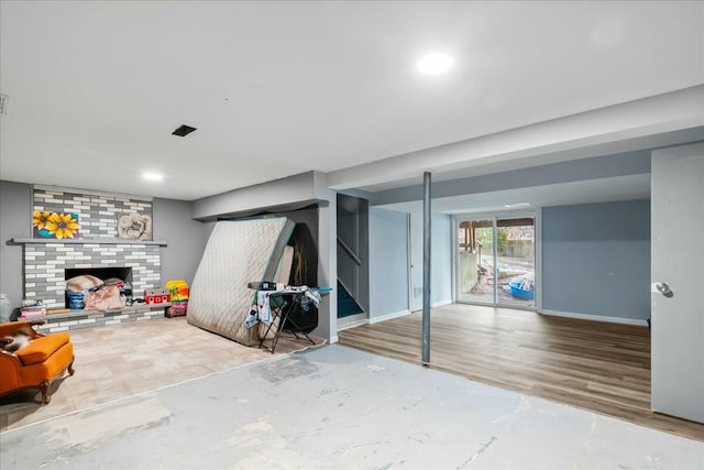 below grade area featuring a fireplace and baseboards