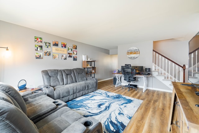 living area featuring stairway, wood finished floors, and baseboards