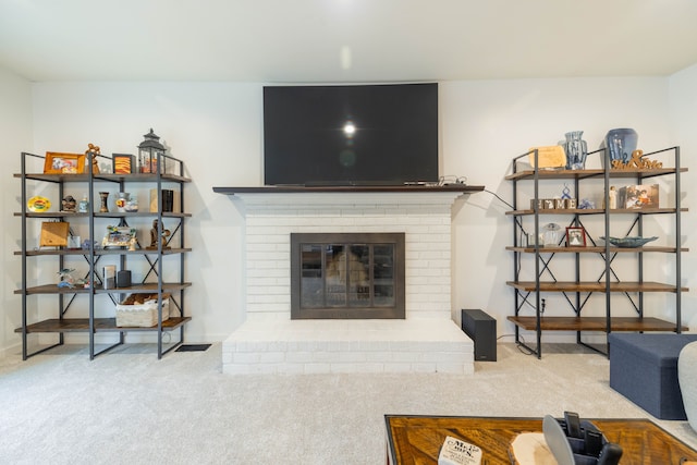 living room featuring carpet flooring, a fireplace, and baseboards