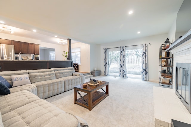 living area featuring recessed lighting, light colored carpet, and baseboards