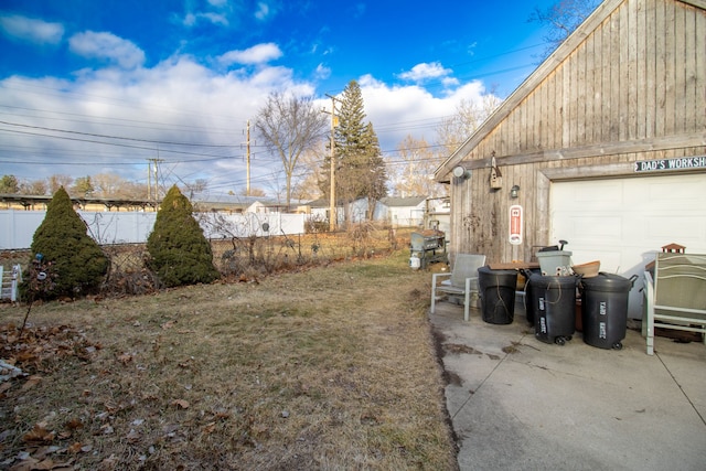 view of yard with a garage and fence