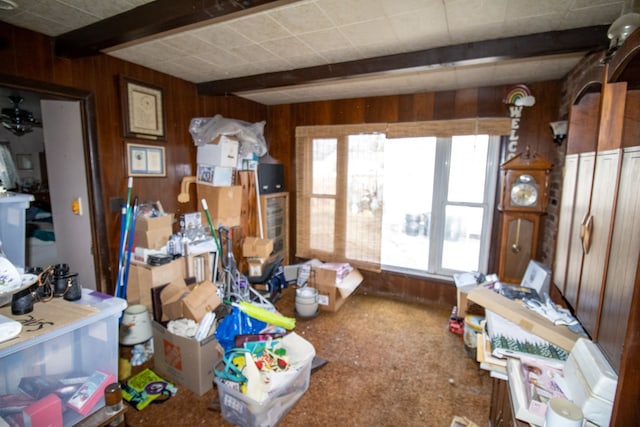 miscellaneous room with wood walls and beam ceiling