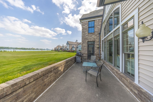 view of patio / terrace featuring a water view and area for grilling