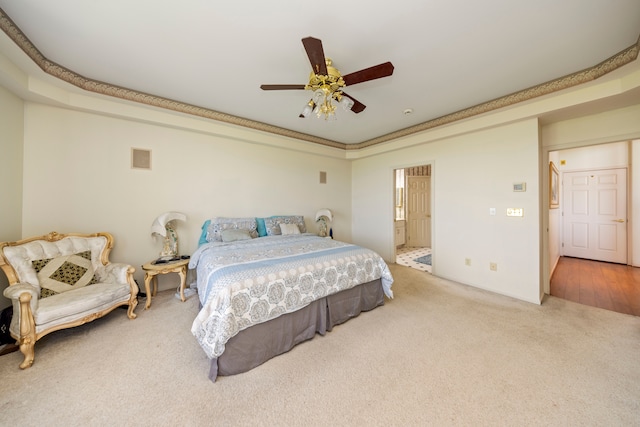 bedroom with carpet floors, ceiling fan, visible vents, and connected bathroom