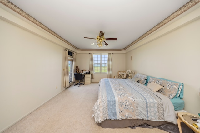 bedroom with crown molding, a ceiling fan, and light colored carpet