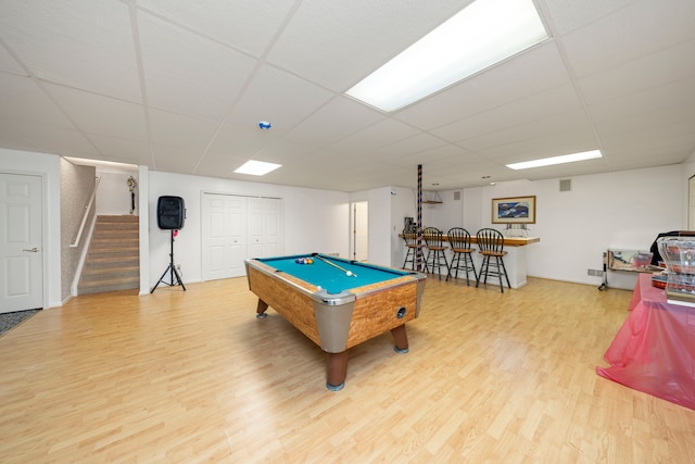 playroom featuring a dry bar, billiards, a drop ceiling, and wood finished floors