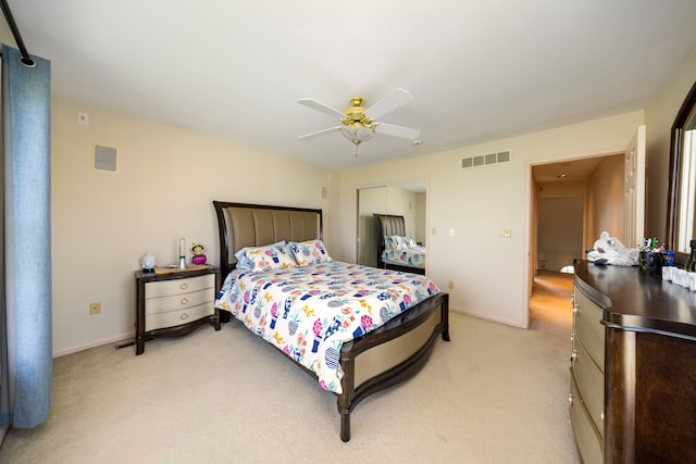 bedroom with baseboards, visible vents, a ceiling fan, and light colored carpet