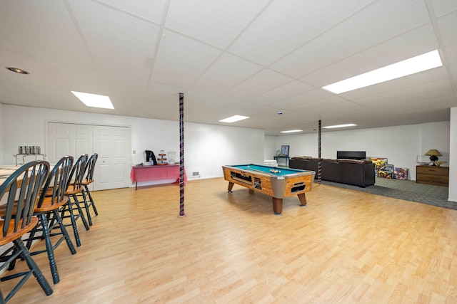 playroom with a paneled ceiling, pool table, and wood finished floors