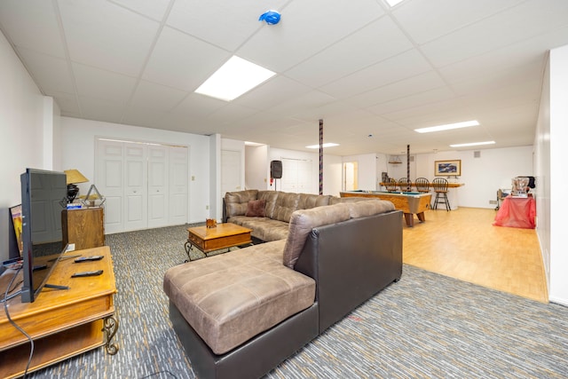 living area with a drop ceiling