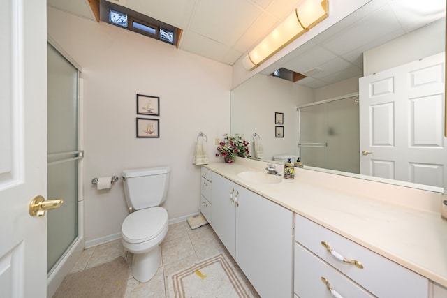 full bathroom featuring toilet, a stall shower, vanity, and tile patterned floors