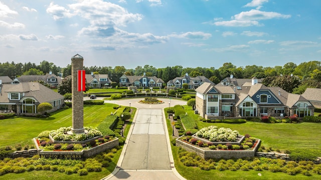 view of home's community featuring a yard, a residential view, and driveway