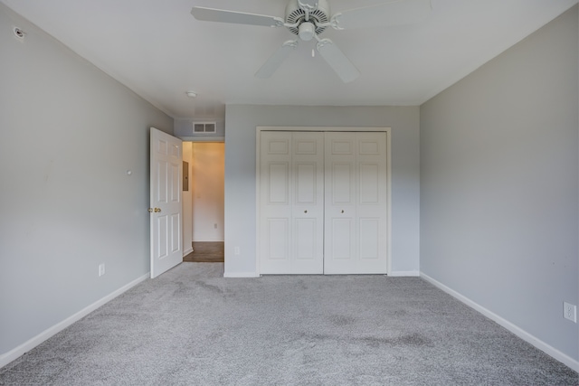 unfurnished bedroom featuring carpet floors, a closet, visible vents, ceiling fan, and baseboards