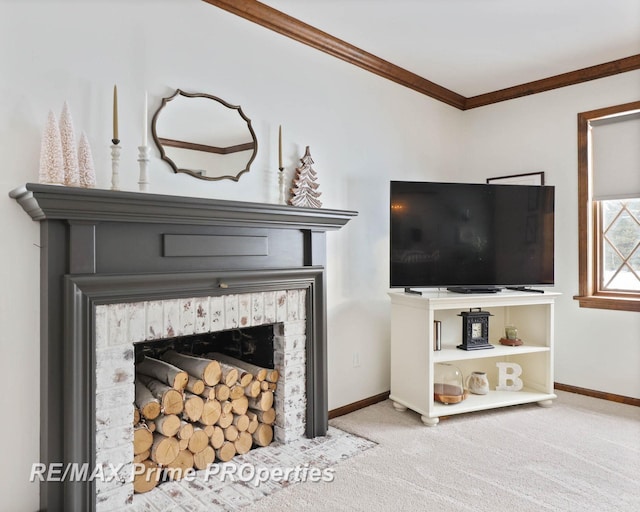 living room with ornamental molding, a brick fireplace, carpet flooring, and baseboards