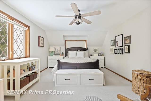 bedroom featuring lofted ceiling, ceiling fan, light carpet, and baseboards