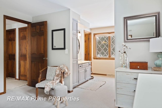 interior space with light carpet, visible vents, and baseboards