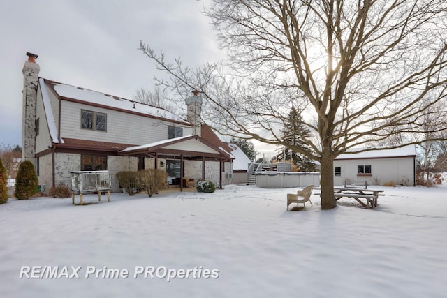 snow covered house with a chimney