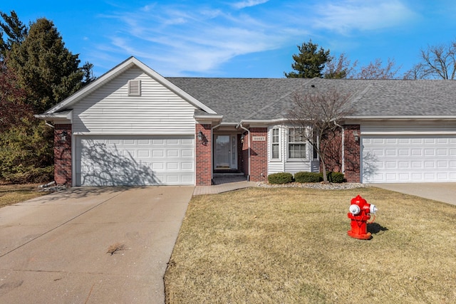 ranch-style house featuring a front lawn, roof with shingles, concrete driveway, a garage, and brick siding