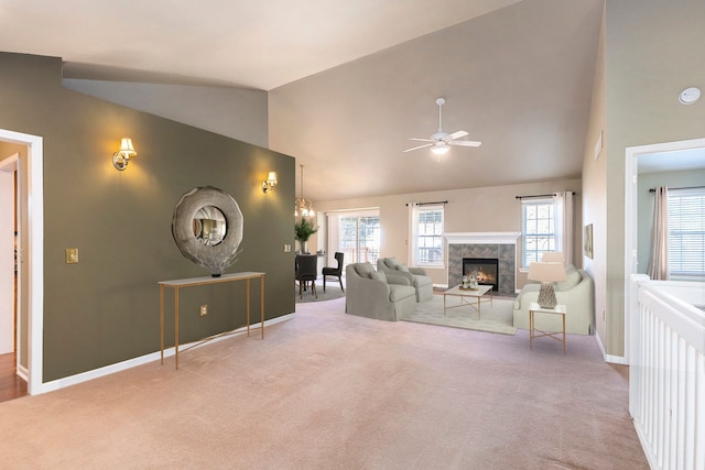 unfurnished living room featuring carpet floors, ceiling fan, and a tiled fireplace