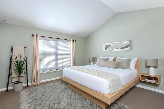 carpeted bedroom featuring baseboards and lofted ceiling